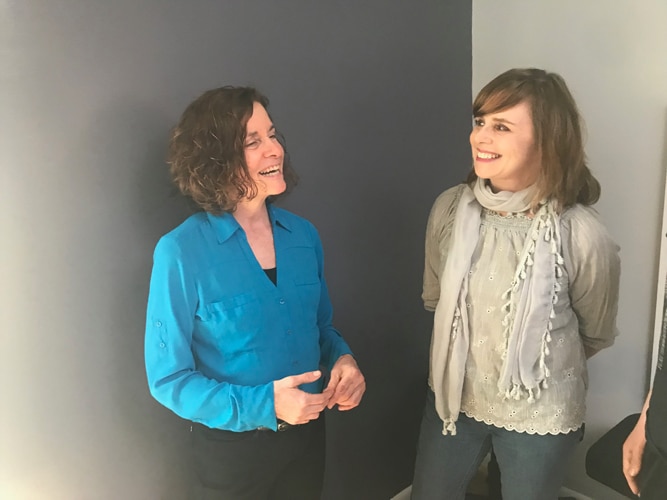 Dr. Kim Pollack welcoming a patient at the front desk
